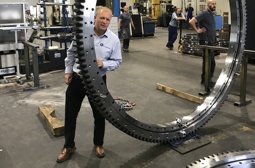 Dave Young, Bearings Product Manager, stood next to large slewing ring used for concert
